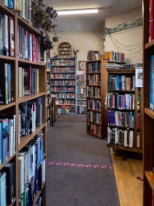 Isles of bookshelves off the entrance of Bad Rock Books