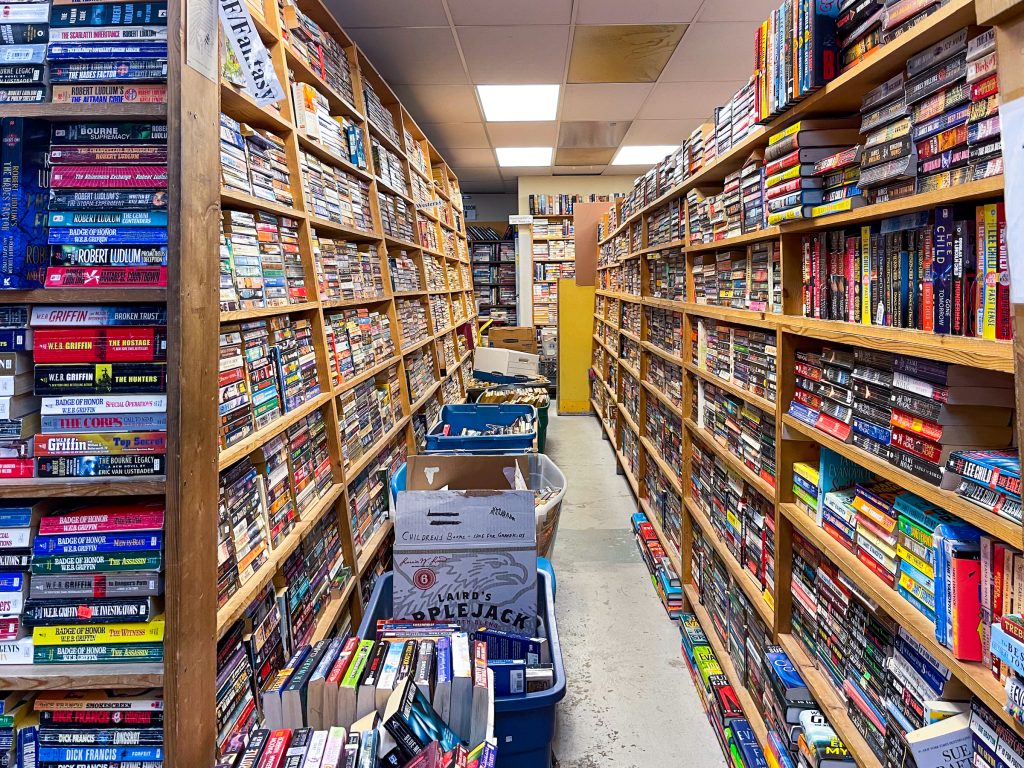 Isles of bookshelves and stacks of books line the hallway of Blacktail Mountain Books