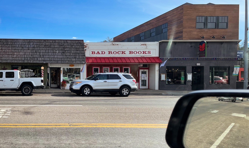 image of the front of Bad Rock Books LLC. The building is mainly white, but has a red trim and the name is in red