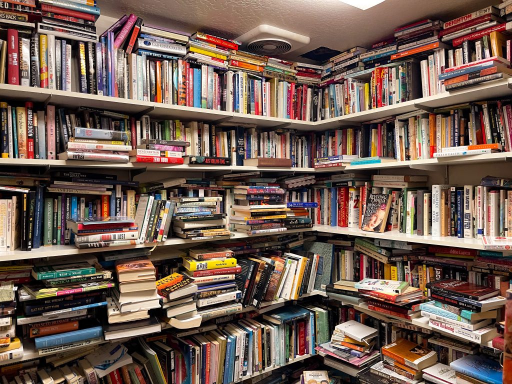 one corner of shelves of books from the floor to the ceiling at Reloved